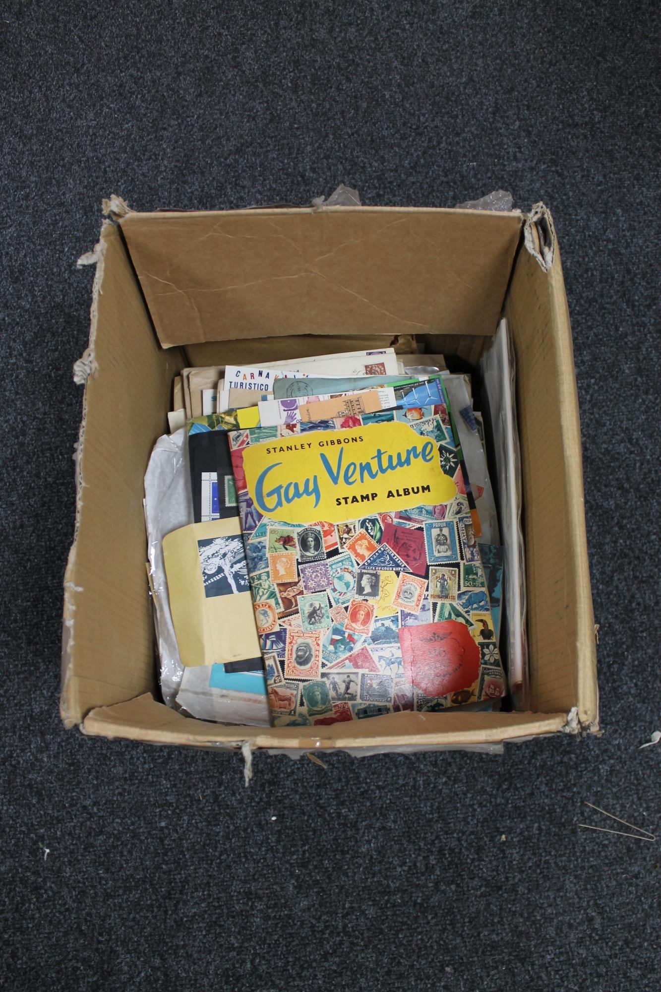 A box of stamps, envelopes with stamps,