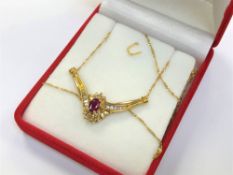 An 18ct yellow gold ruby and diamond set pendant on chain