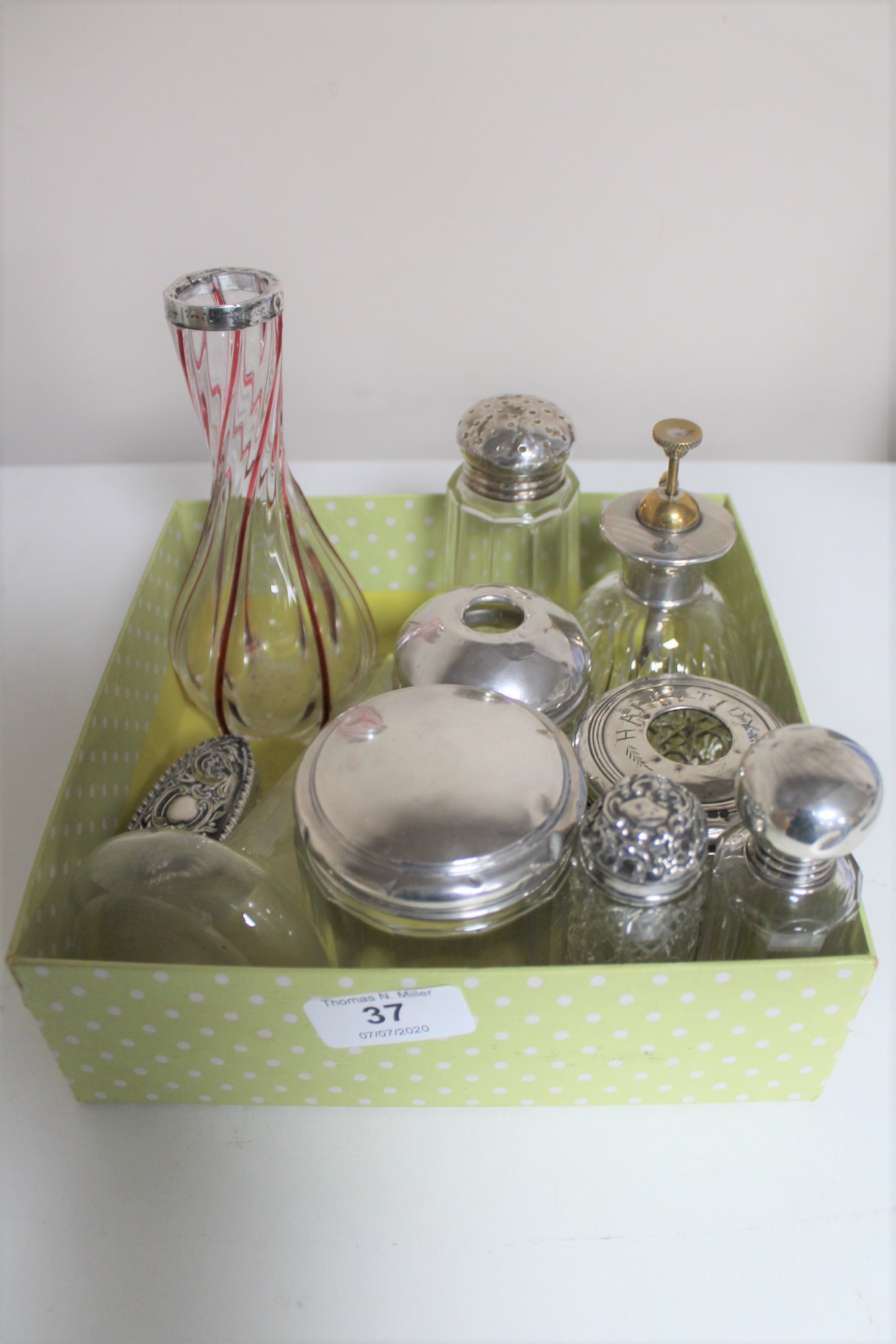 A box of eight silver topped dressing table items and bottles, two silver rimmed vases.