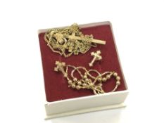 A pair of 9ct gold crucifix earrings, a broken 9ct gold chain and a gilt metal crucifix on chain.