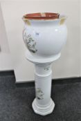 A decorative ceramic jardiniere on stand