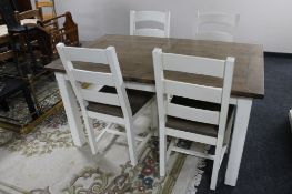A contemporary farmhouse dining room table and four chairs