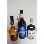 Three bottles of alcohol - Woods Old navy rum 70cl, Cuarenta Y Tres 700ml and Caribbean dark rum 1l.