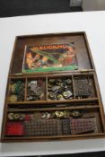 A vintage wooden box containing Meccano