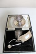 Two silver egg cups and spoons.