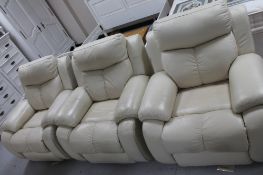 Three cream leather armchairs and a footstool