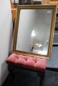 A gilt framed mirror and a buttoned stool