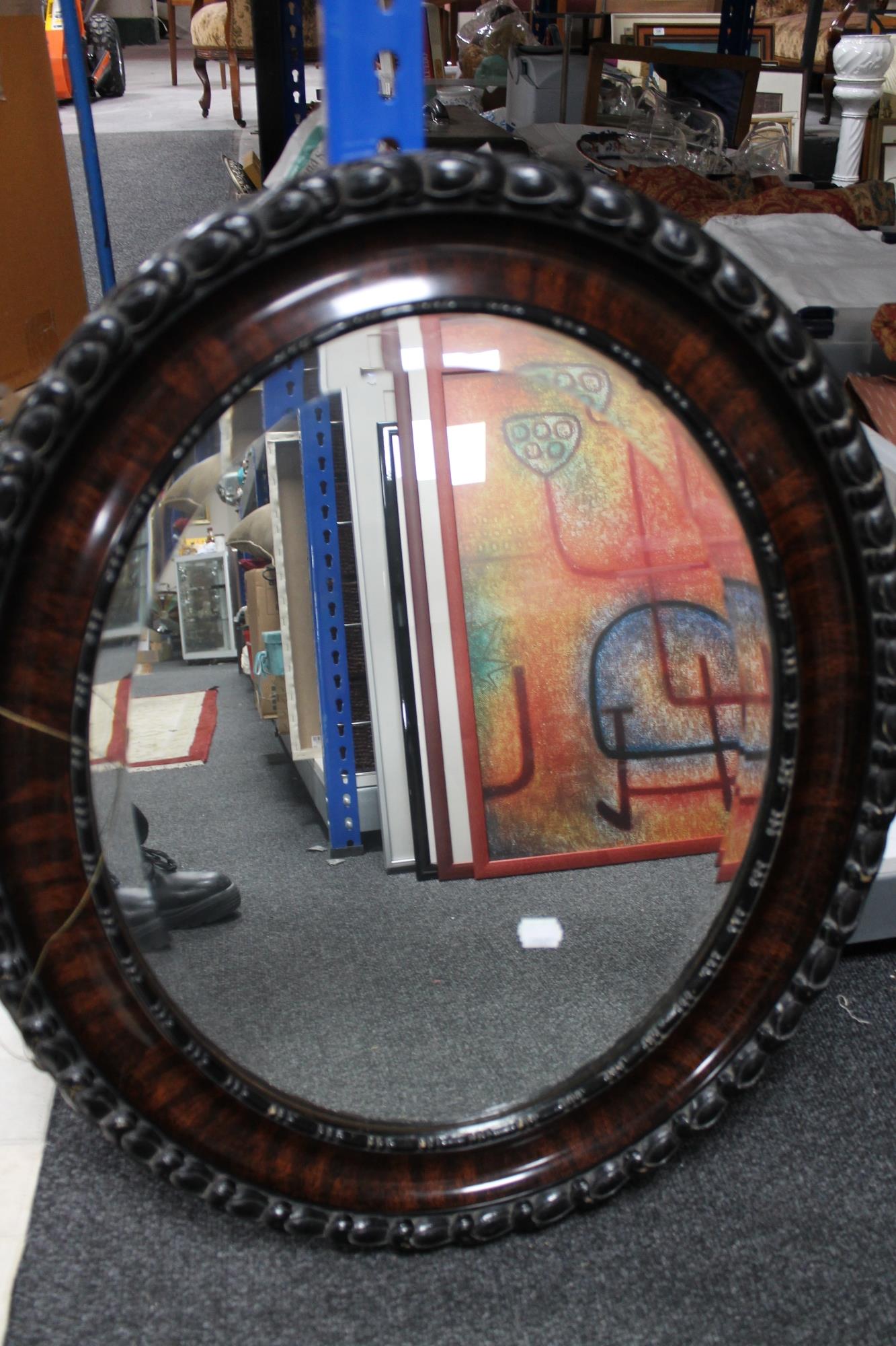 An Edwardian bevelled oval mirror