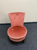 A pink buttoned dralon bedroom chair
