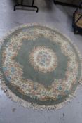 A fringed circular Chinese rug plus another