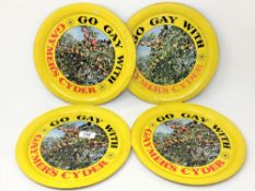 A set of four cirular tin pub trays : GO GAY WITH GAYMER'S CIDER, diameter 26 cm.