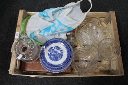 A crate of glass bowls, blue and white plates, quantity of cutlery,