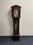 A reproduction mahogany granddaughter clock