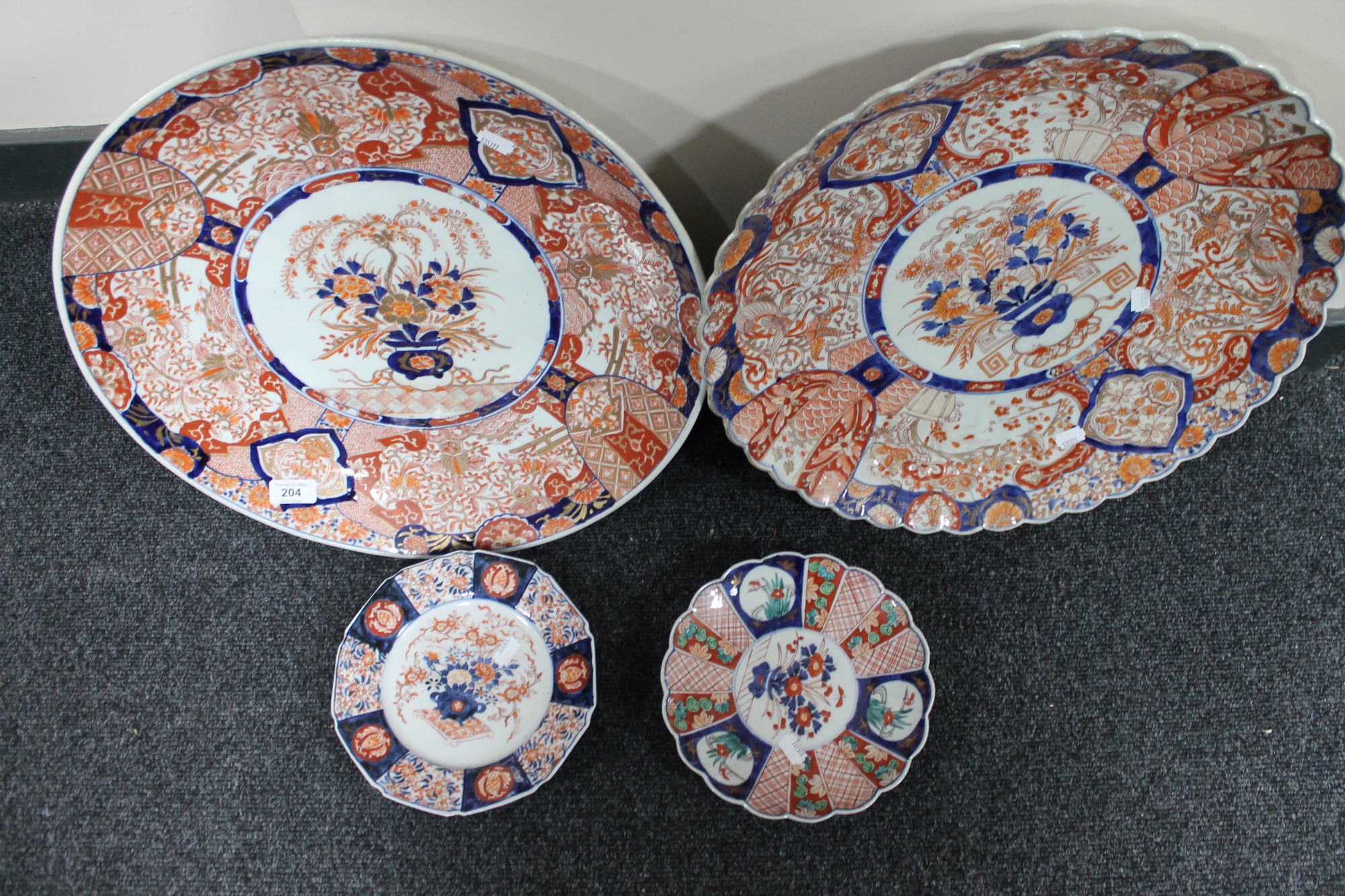 A nineteenth century Imari charger, together with further Japanese plaques/plates.
