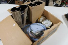 Two boxes of place mats, three mantel clocks, barometer,