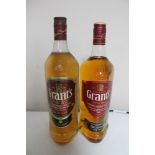Two bottles of whisky - Grants Blended Scotch 1l and Grants Triple Wood blended scotch 1l.