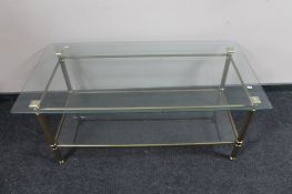 A contemporary brass topped glass coffee table