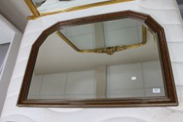 A bevelled overmantel mirror