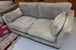 A contemporary two seater cloth settee with matching oversized armchair