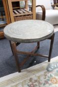 A brass topped folding occasional table with eastern design CONDITION REPORT: 52cm