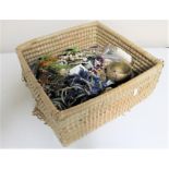 A wicker crate of costume jewellery