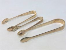 Three sets of silver sugar tongs (3) CONDITION REPORT: 70.