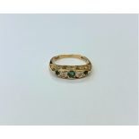 An 18ct gold emerald and diamond ring