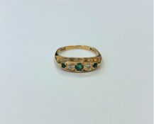 An 18ct gold emerald and diamond ring