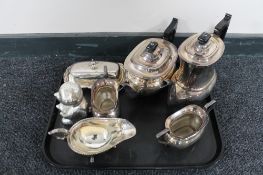 A tray of silver plated items,