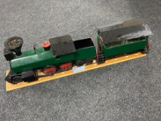 A hand built wooden model of a steam train with carriage