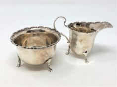 A shaped silver sugar bowl and matching cream jug,