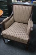 A reproduction mahogany striped armchair