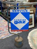 An enamelled Camping Gaz Service International sign on stand