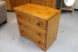 A pine three drawer chest