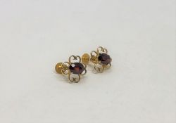 A pair of 9ct gold garnet set earrings (2)