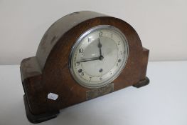 An early 20th century oak mantel clock