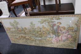 A large tapestry depicting figures in a landscape