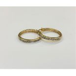A pair of 10ct gold diamond set hoop earrings