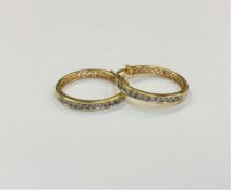 A pair of 10ct gold diamond set hoop earrings