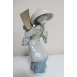 A Lladro figure - lady carrying child