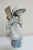 A Lladro figure - lady carrying child