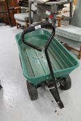 Two plastic garden trolleys together with a hose pipe on reel