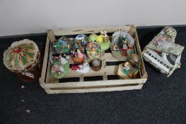 A crate of decorative globes, ornamental ceramic piano,