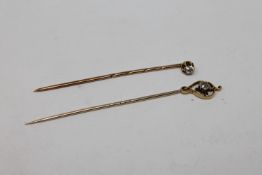 Two antique gold diamond set stick pins, about 0.