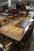A good quality reproduction farmhouse extending dining room table together with a set of eight