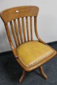 An Edwardian oak swivel office chair