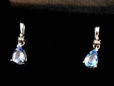 A pair of white gold diamond and blue topaz drop earrings