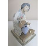 A Lladro figure - Lady flower arranging