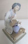 A Lladro figure - Lady flower arranging