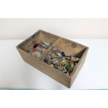 A wooden crate of costume jewellery, bangles,